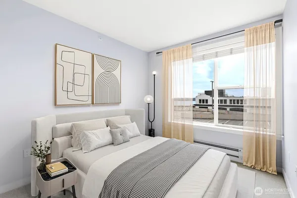 a bedroom with a large bed and a large window