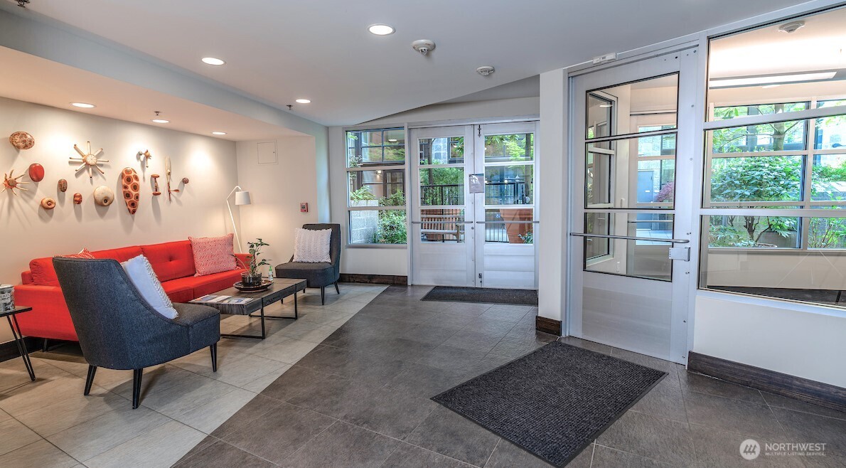 2607 Western Avenue, Unit 452 Seattle, WA 98121 - Photo 4 of 26 a living room with furniture and a large window
