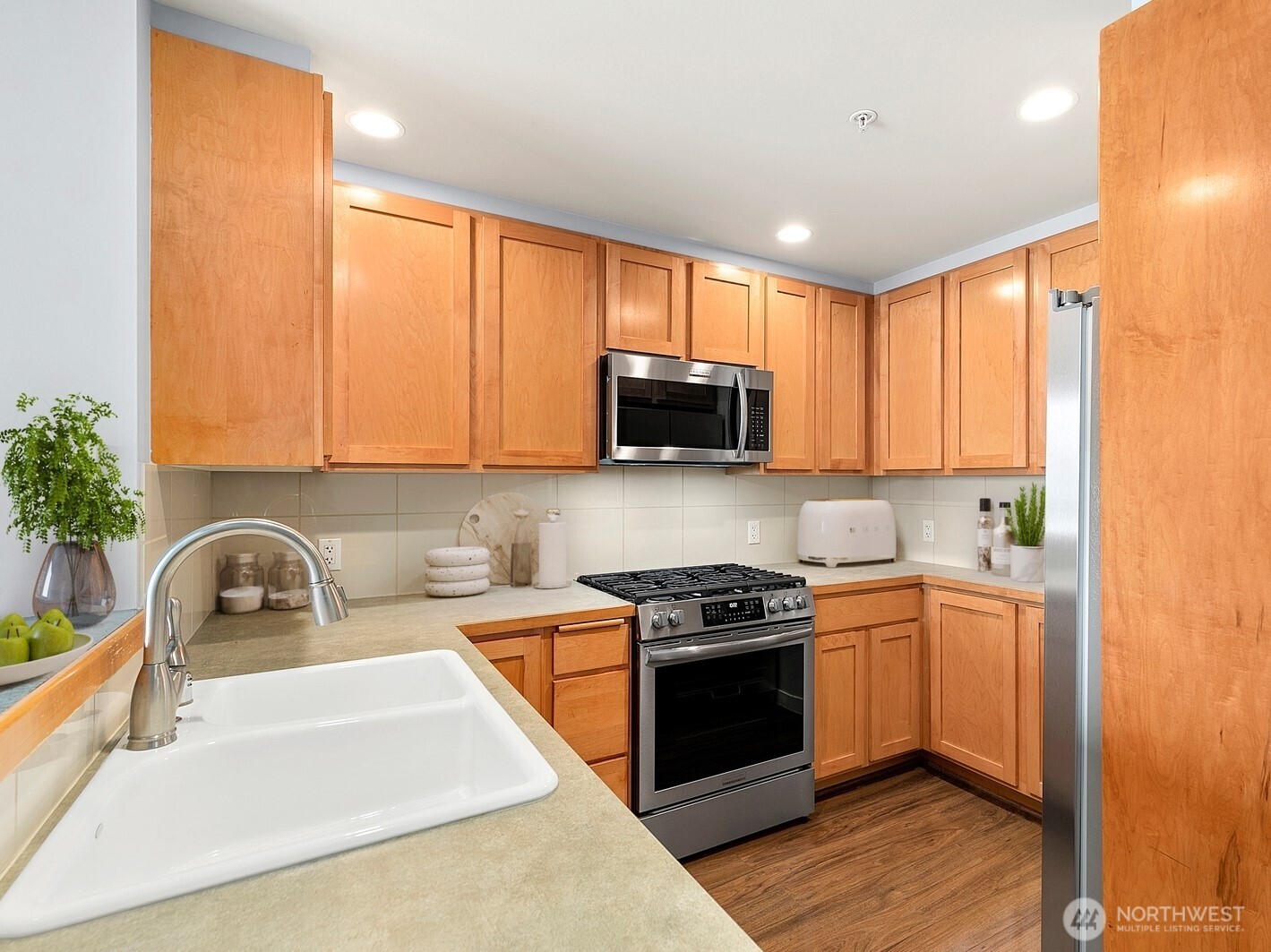 2607 Western Avenue, Unit 452 Seattle, WA 98121 - Photo 7 of 25 a kitchen with stainless steel appliances granite countertop a sink a stove a microwave a refrigerator and cabinets