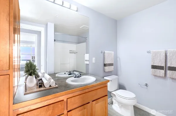 a bathroom with a sink a toilet and mirror