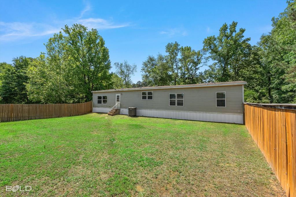 2153 Highway 2 Plain Dealing, LA 71064 - Photo 9 of 39 a view of a house with backyard and trees