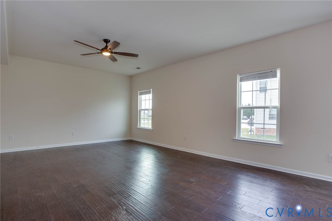 12219 Almer Lane Chester, VA 23836 - Photo 12 of 46 a view of an empty room with a window and wooden floor