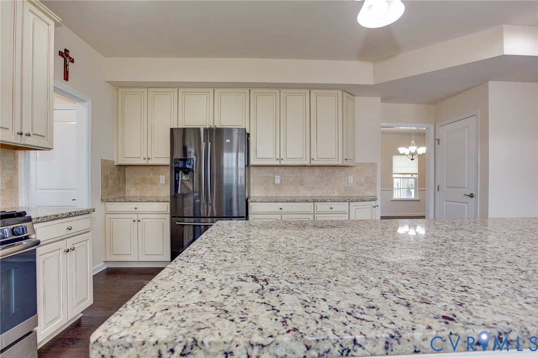 12219 Almer Lane Chester, VA 23836 - Photo 18 of 46 a kitchen with granite countertop a refrigerator and stove