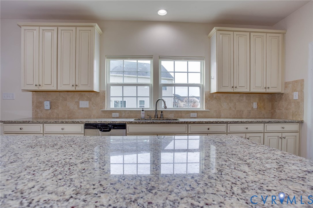 12219 Almer Lane Chester, VA 23836 - Photo 19 of 46 a kitchen with stainless steel appliances granite countertop a stove a sink and white cabinets