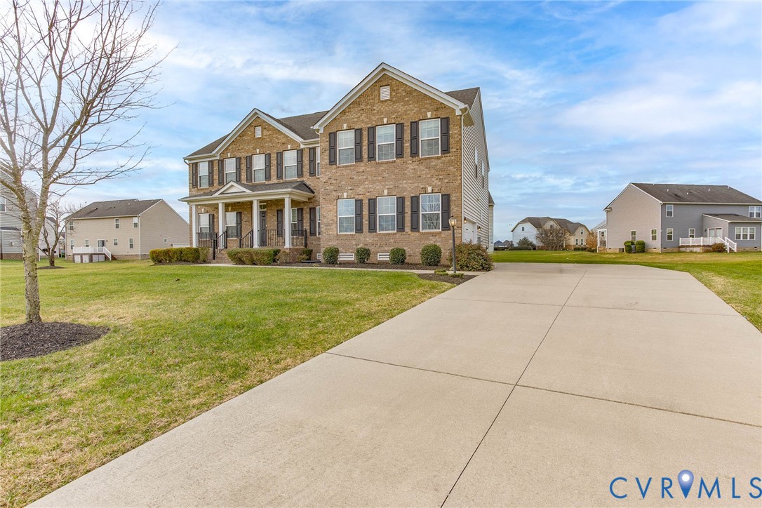 12219 Almer Lane Chester, VA 23836 - Photo 2 of 46 a front view of a house with a yard