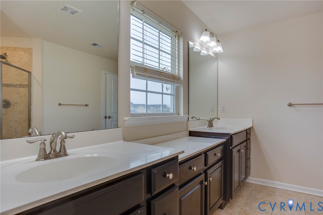12219 Almer Lane Chester, VA 23836 - Photo 32 of 46 a bathroom with a granite countertop sink a large mirror and a window