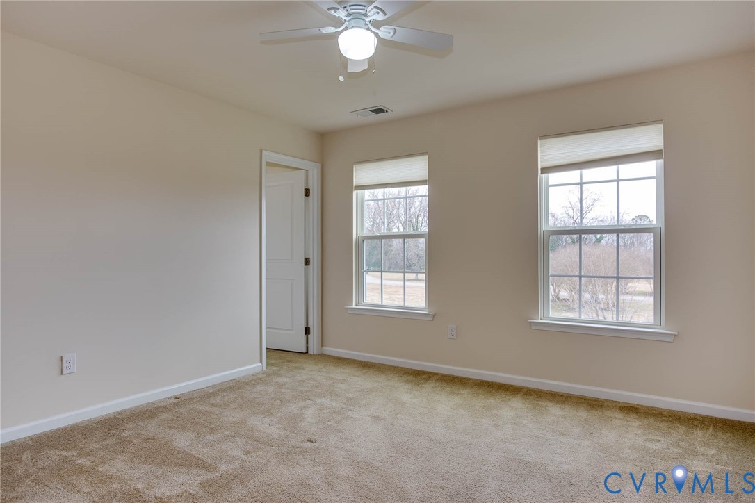 12219 Almer Lane Chester, VA 23836 - Photo 37 of 46 an empty room with chandelier fan and windows