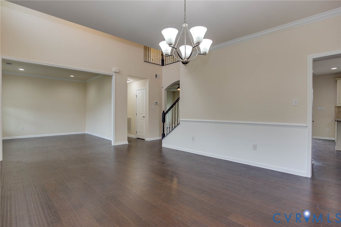 12219 Almer Lane Chester, VA 23836 - Photo 5 of 46 a view of a room with wooden floor and a chandelier
