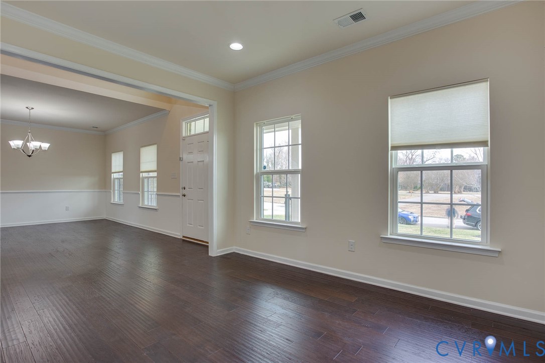 12219 Almer Lane Chester, VA 23836 - Photo 9 of 46 a view of an empty room with wooden floor and windows