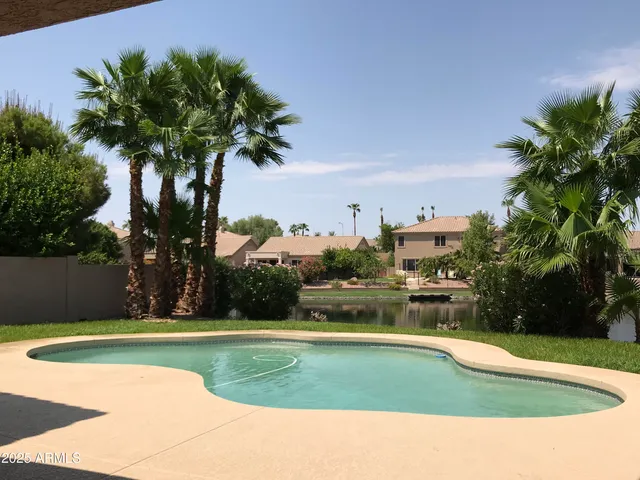 a view of a swimming pool and trees in the background
