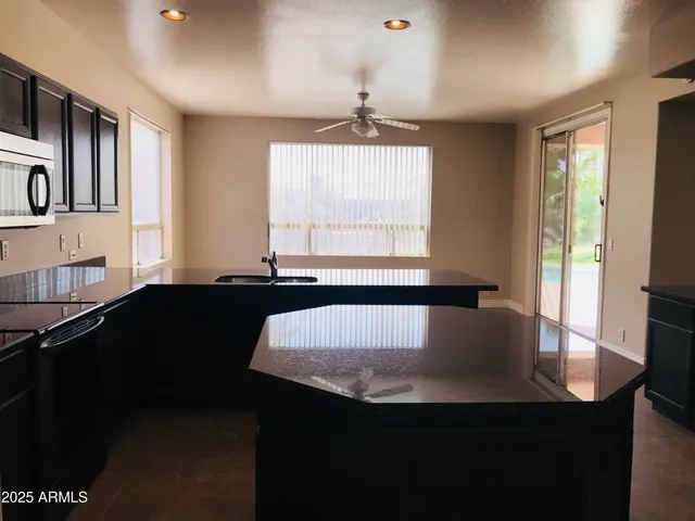 a view of kitchen and kitchen with windows