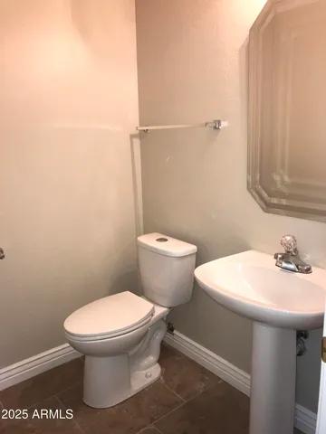 a white toilet sitting next to a bathroom sink