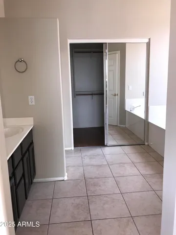a view of an empty room with a kitchen
