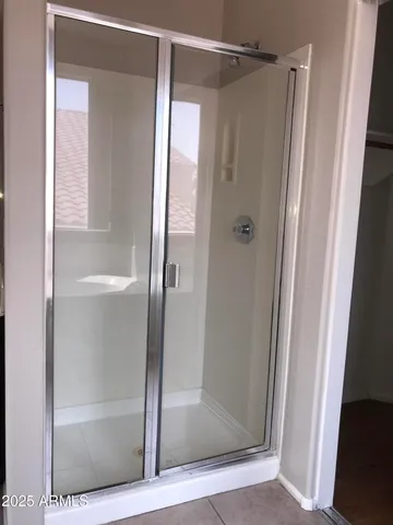 a bathroom with a glass shower door