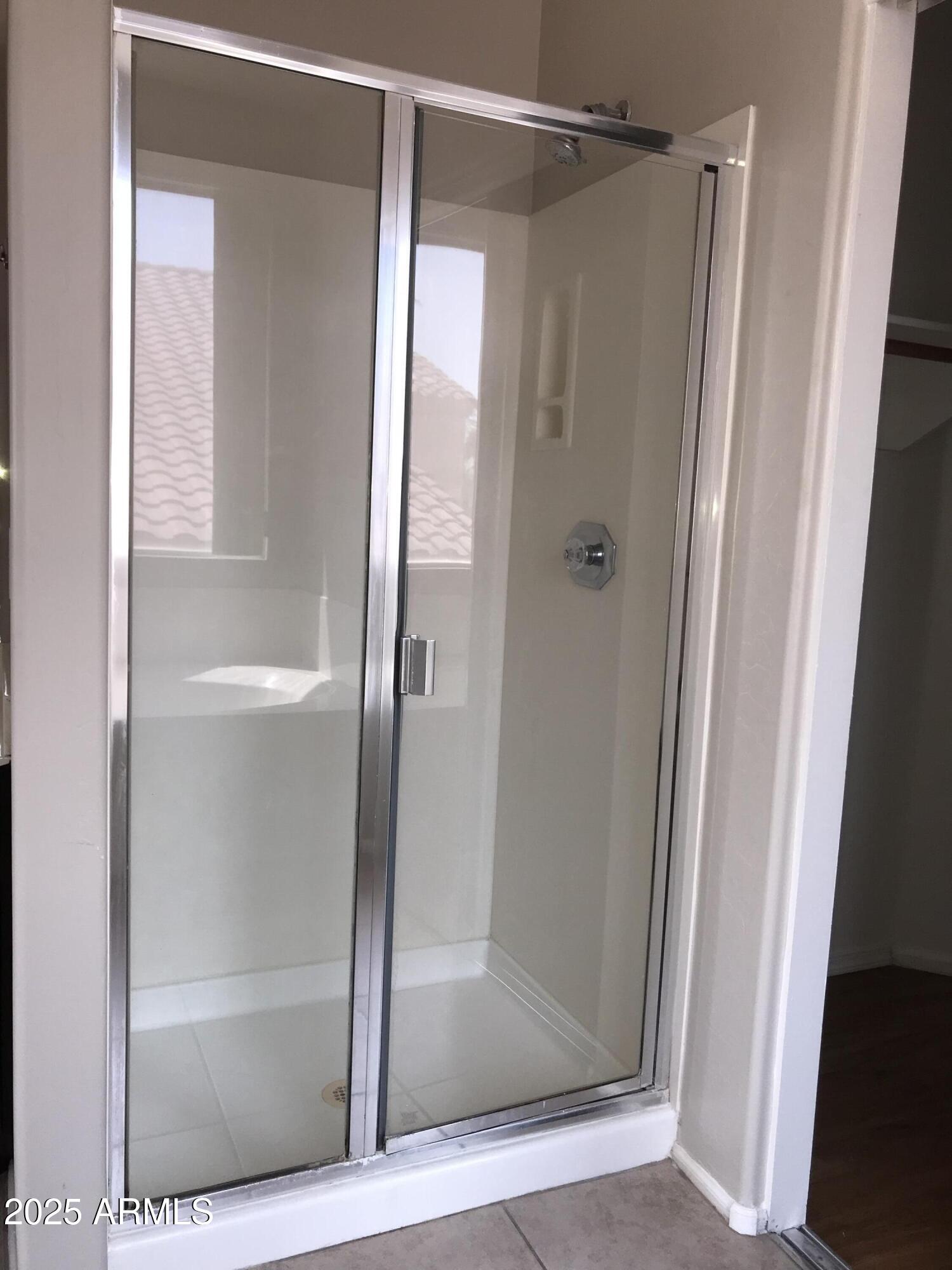 3670 South Heath Way Chandler, AZ 85248 - Photo 21 of 29 a bathroom with a glass shower door