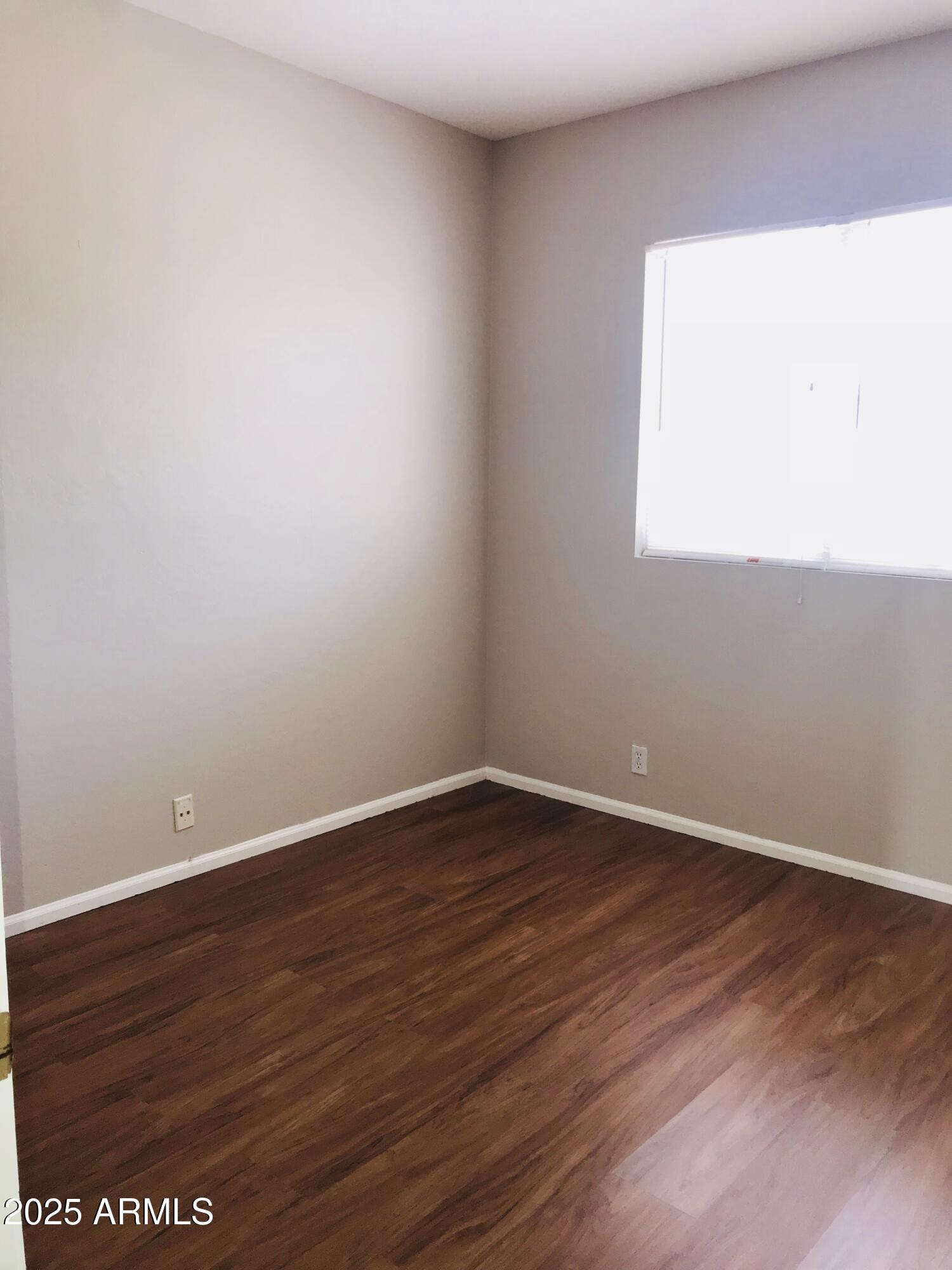 3670 South Heath Way Chandler, AZ 85248 - Photo 25 of 29 a view of an empty room with wooden floor and a window