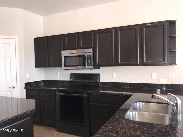 a kitchen that has a sink and a microwave