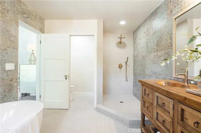a bathroom with a double vanity sink mirror and next to a window