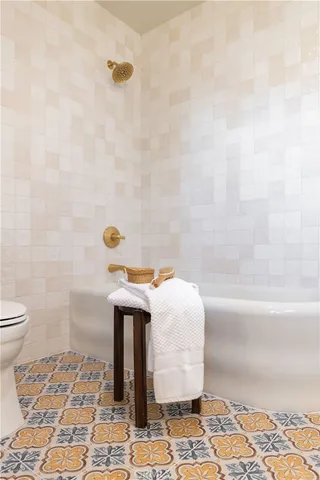 a front view of a house with a big yard and a large tree