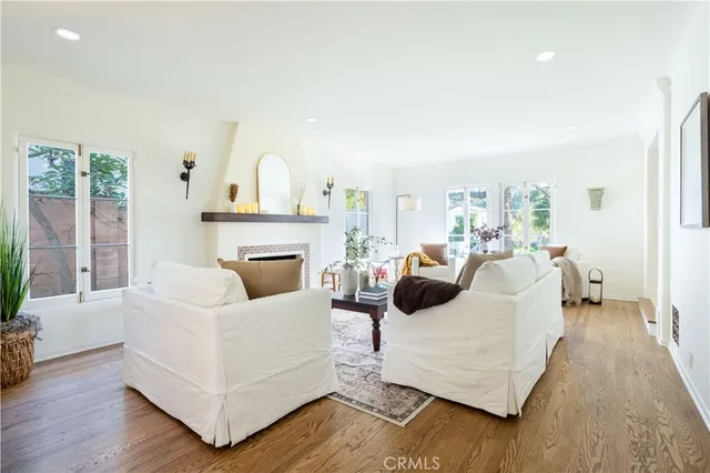 a living room with furniture couches and a view of kitchen