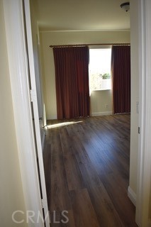 1746 Dalea Way Beaumont, CA 92223 - Photo 11 of 35 a view of an empty room with wooden floor and a window