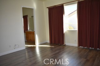 1746 Dalea Way Beaumont, CA 92223 - Photo 12 of 35 an empty room with wooden floor and windows