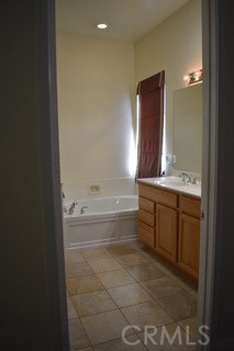 1746 Dalea Way Beaumont, CA 92223 - Photo 13 of 35 a bathroom with a bathtub sink and mirror