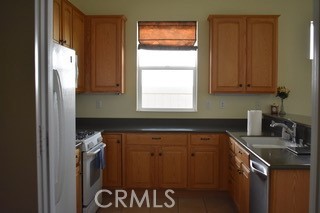 1746 Dalea Way Beaumont, CA 92223 - Photo 29 of 35 a kitchen with a sink and cabinets