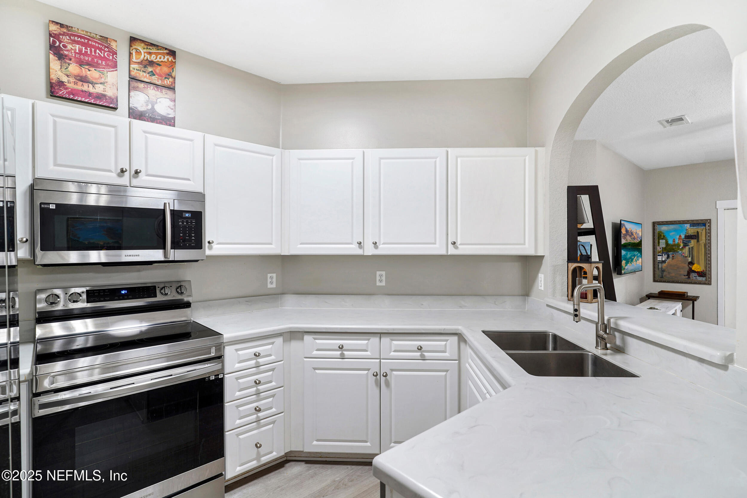 1125 Vista Cove Road St. Augustine, FL 32084 - Photo 11 of 62 a kitchen with stainless steel appliances a stove a sink and a microwave