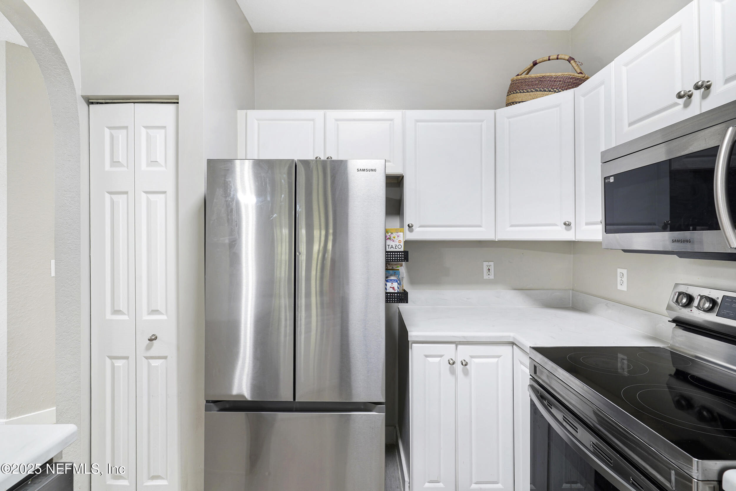 1125 Vista Cove Road St. Augustine, FL 32084 - Photo 13 of 62 a kitchen with stainless steel appliances a refrigerator sink and microwave