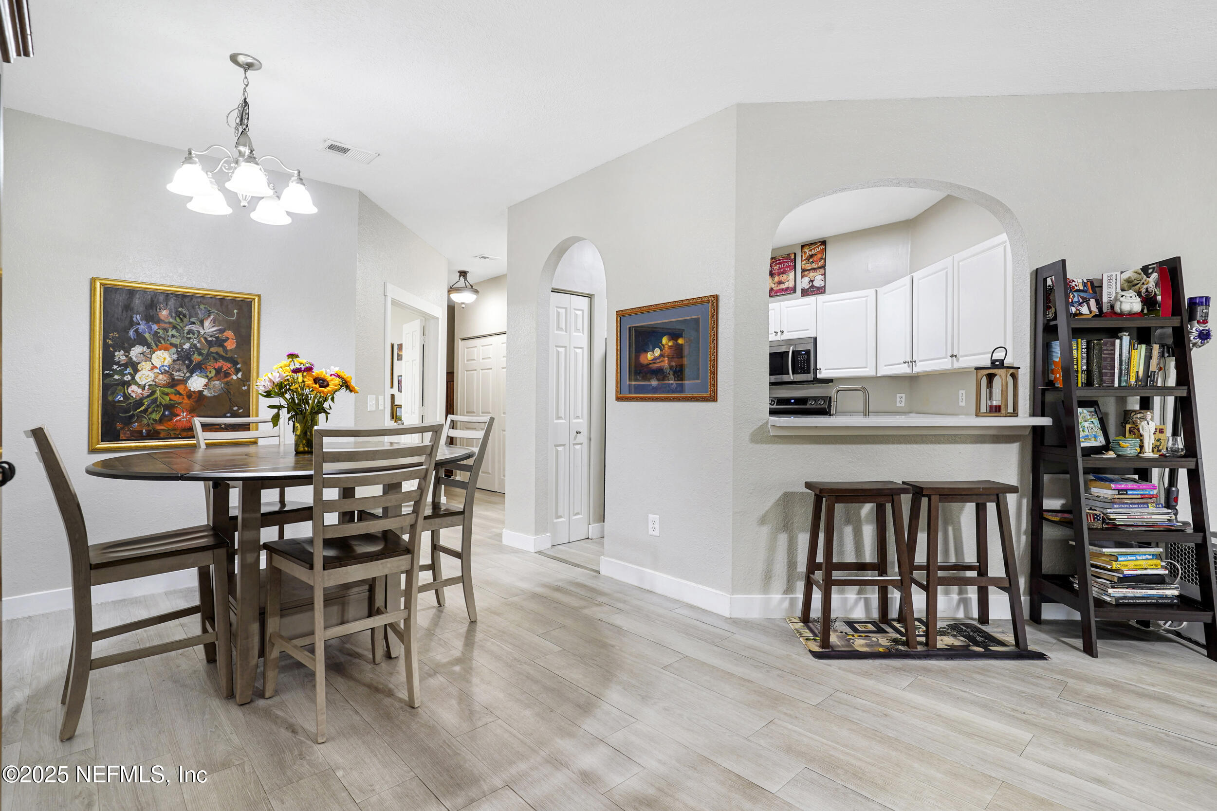 1125 Vista Cove Road St. Augustine, FL 32084 - Photo 14 of 62 a view of a dining room with furniture and wooden floor
