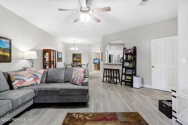 a en suite bathroom with a double vanity sink a mirror and a bathtub