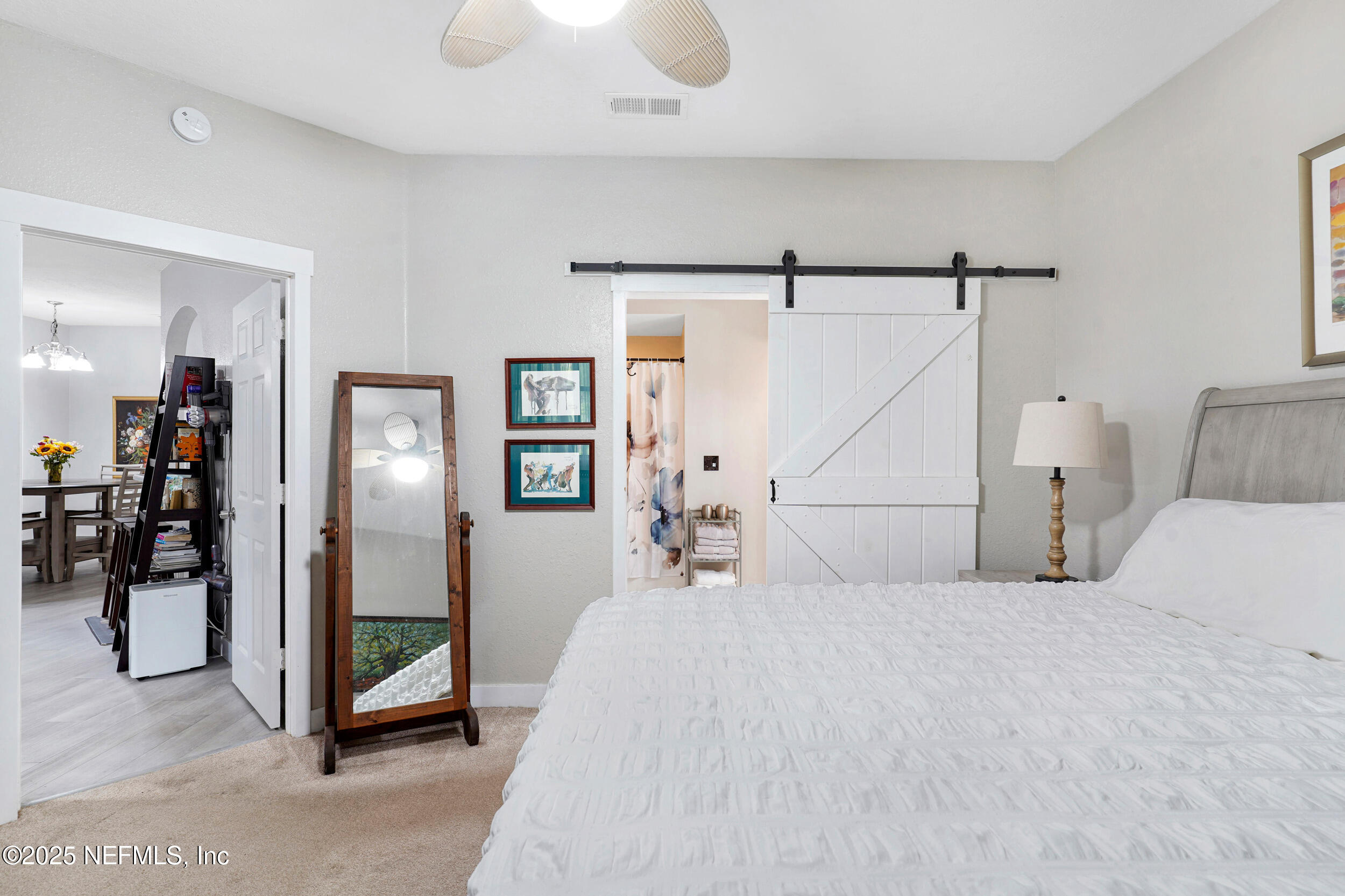 1125 Vista Cove Road St. Augustine, FL 32084 - Photo 17 of 62 a bedroom with a bed and a mirror