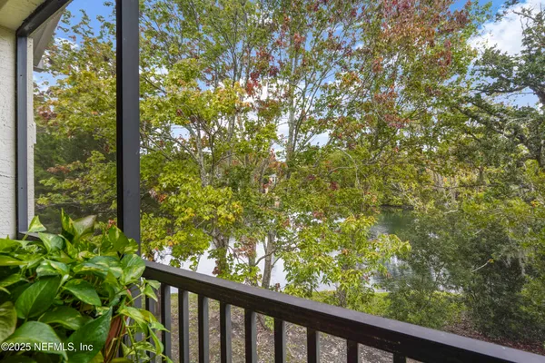 a view of a workspace with furniture and a flat screen tv