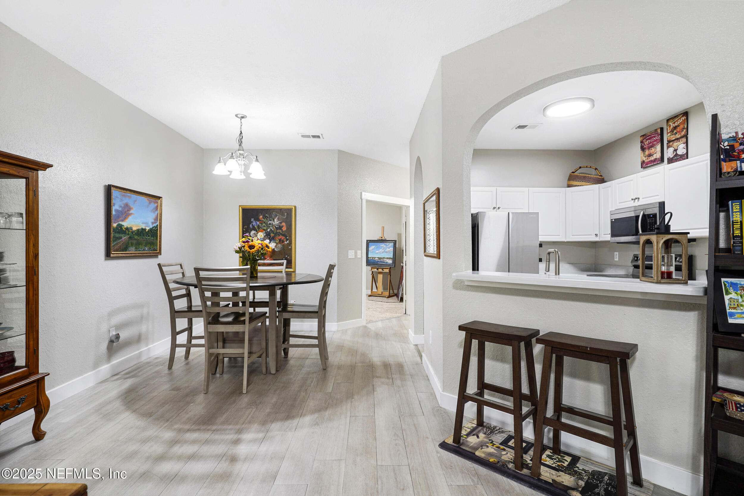 1125 Vista Cove Road St. Augustine, FL 32084 - Photo 25 of 62 a view of a dining room with furniture and wooden floor