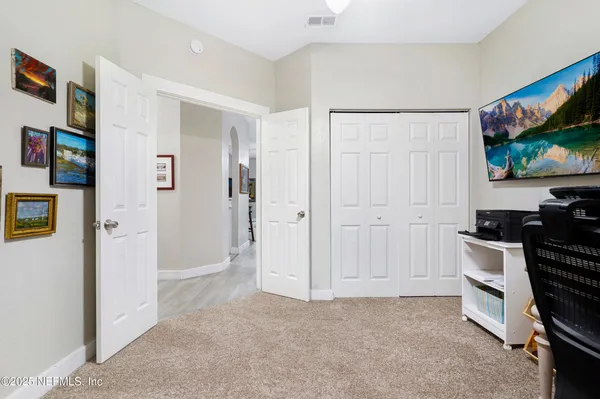 a bedroom with bed and a chandelier