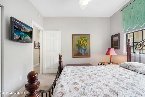 a view of a hallway with wooden floor and a large window