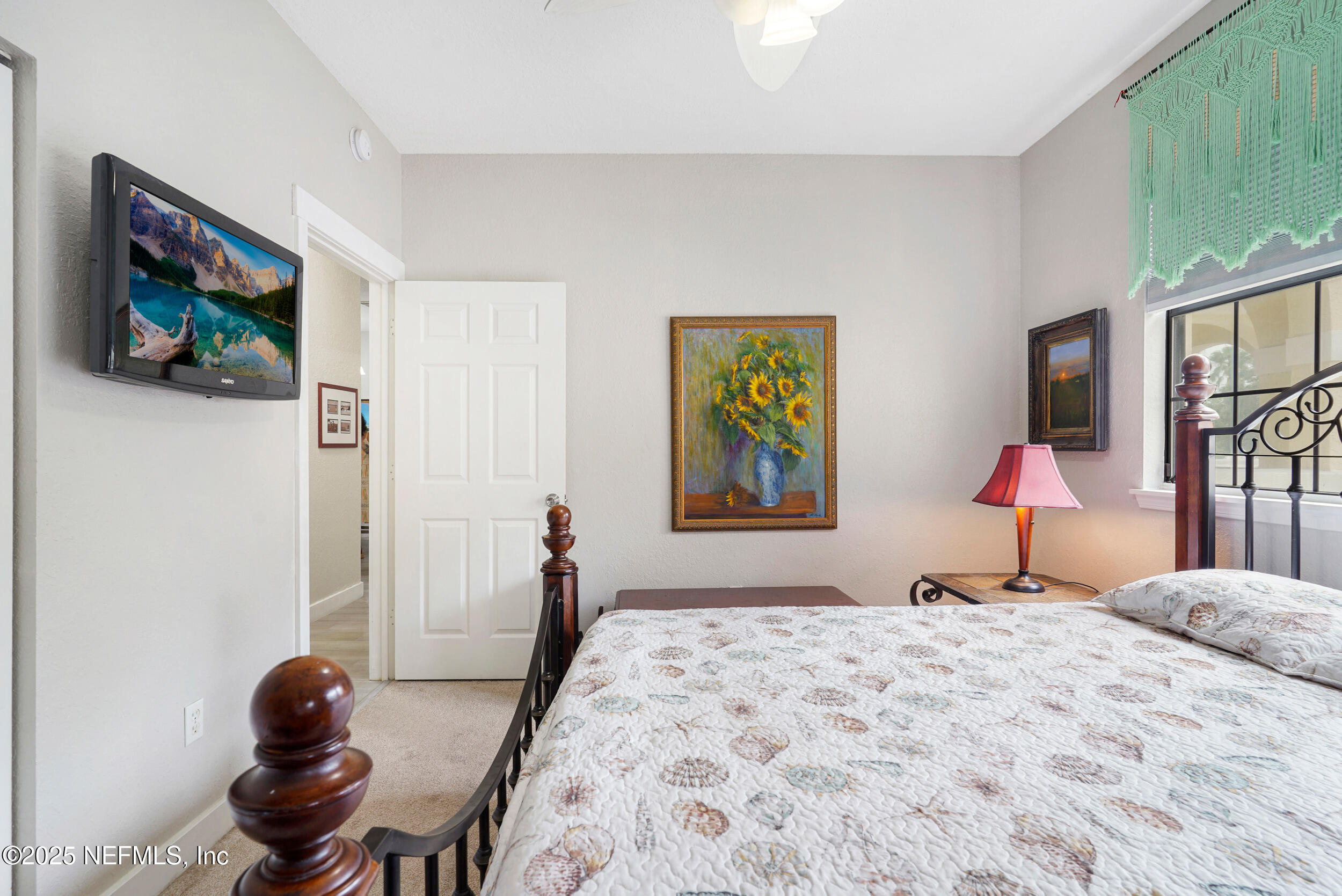 1125 Vista Cove Road St. Augustine, FL 32084 - Photo 32 of 62 a bedroom with a bed and a flat screen tv