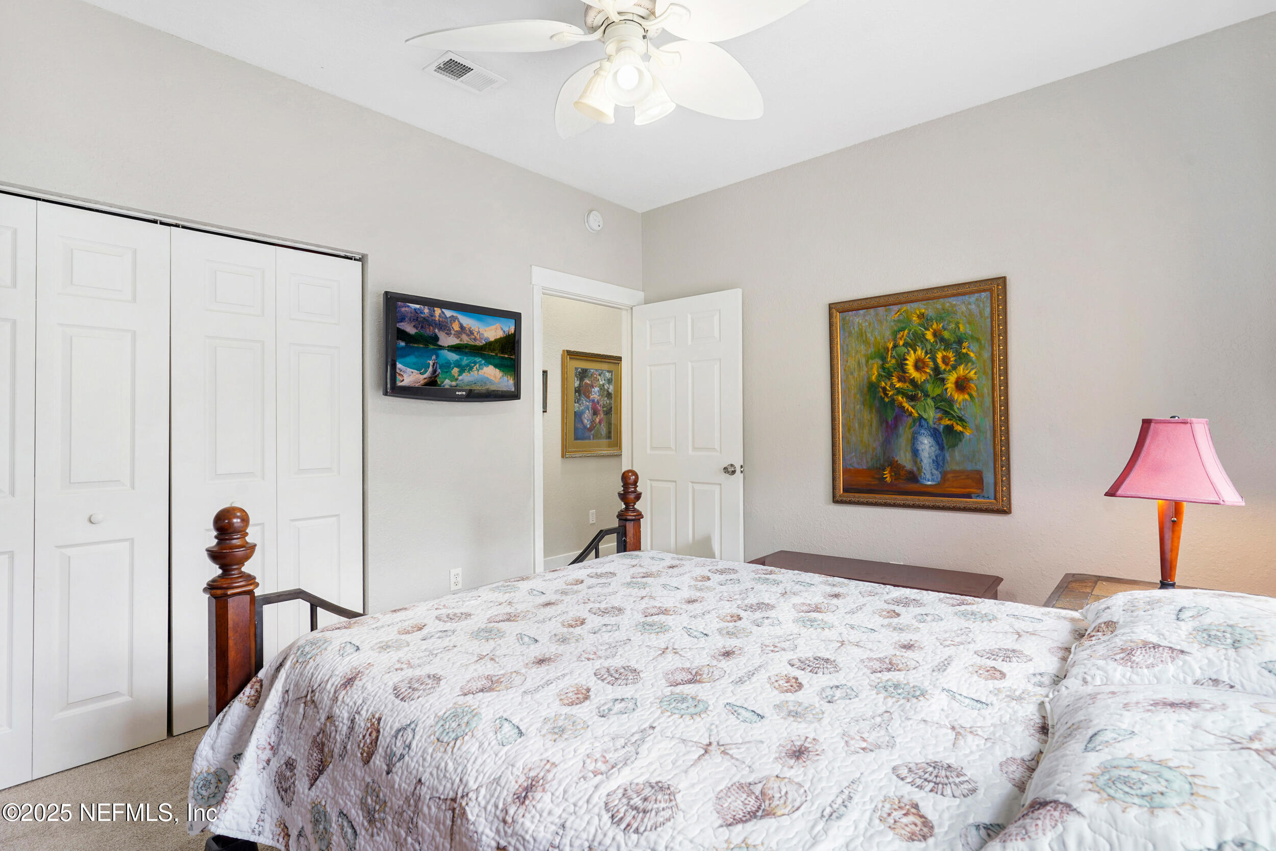 1125 Vista Cove Road St. Augustine, FL 32084 - Photo 33 of 62 a bedroom with bed and a chandelier