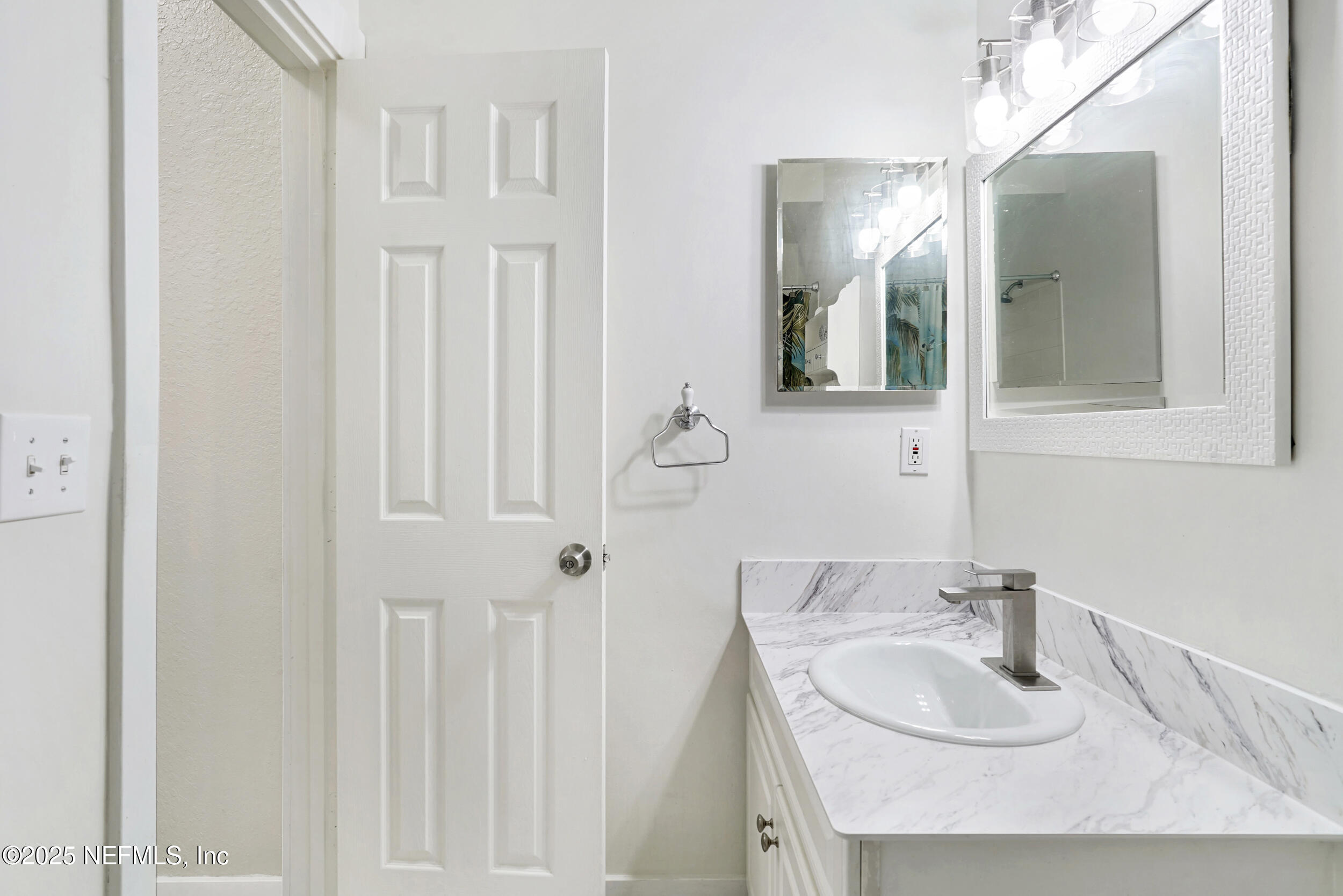 1125 Vista Cove Road St. Augustine, FL 32084 - Photo 34 of 62 a bathroom with a sink and a mirror