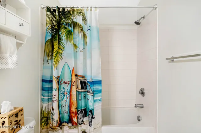 an aerial view of residential houses with outdoor space and trees all around