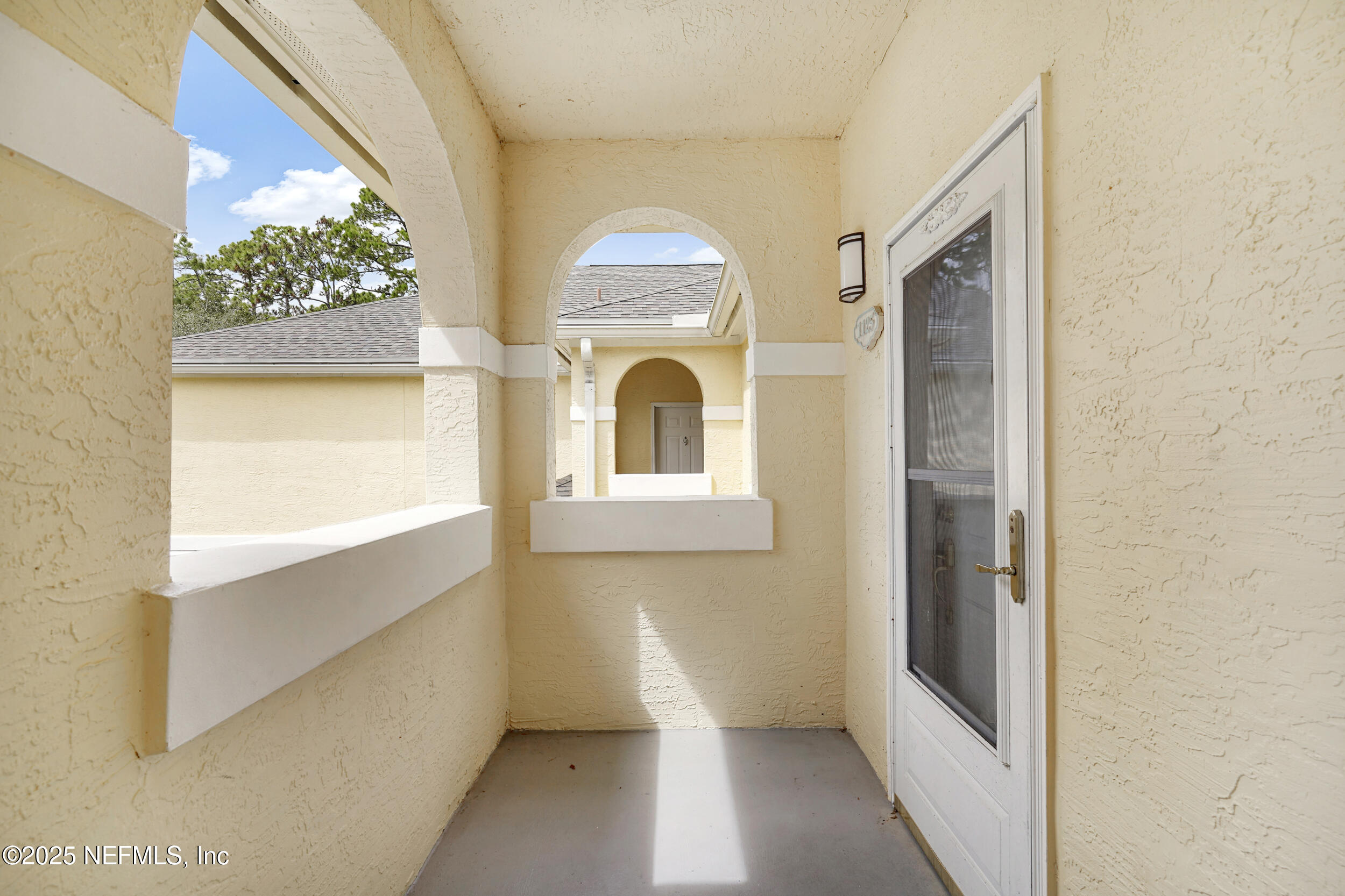 1125 Vista Cove Road St. Augustine, FL 32084 - Photo 37 of 62 a view of a hallway with wooden floor and a large window