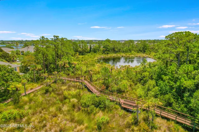 a balcony with chairs and a potted plant
