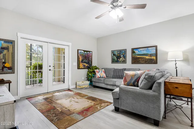 a kitchen with sink cabinets and a clock on the wall