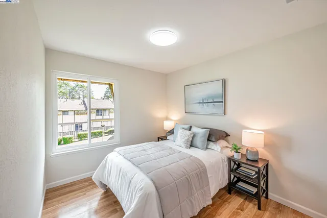 a bedroom with a bed and a painting on the wall