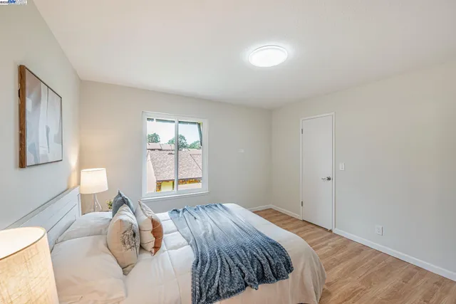 a bedroom with bed and night stand