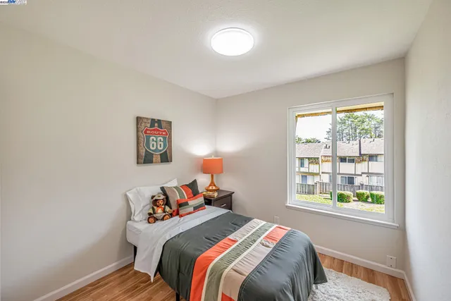 a bedroom with a bed and cupboard