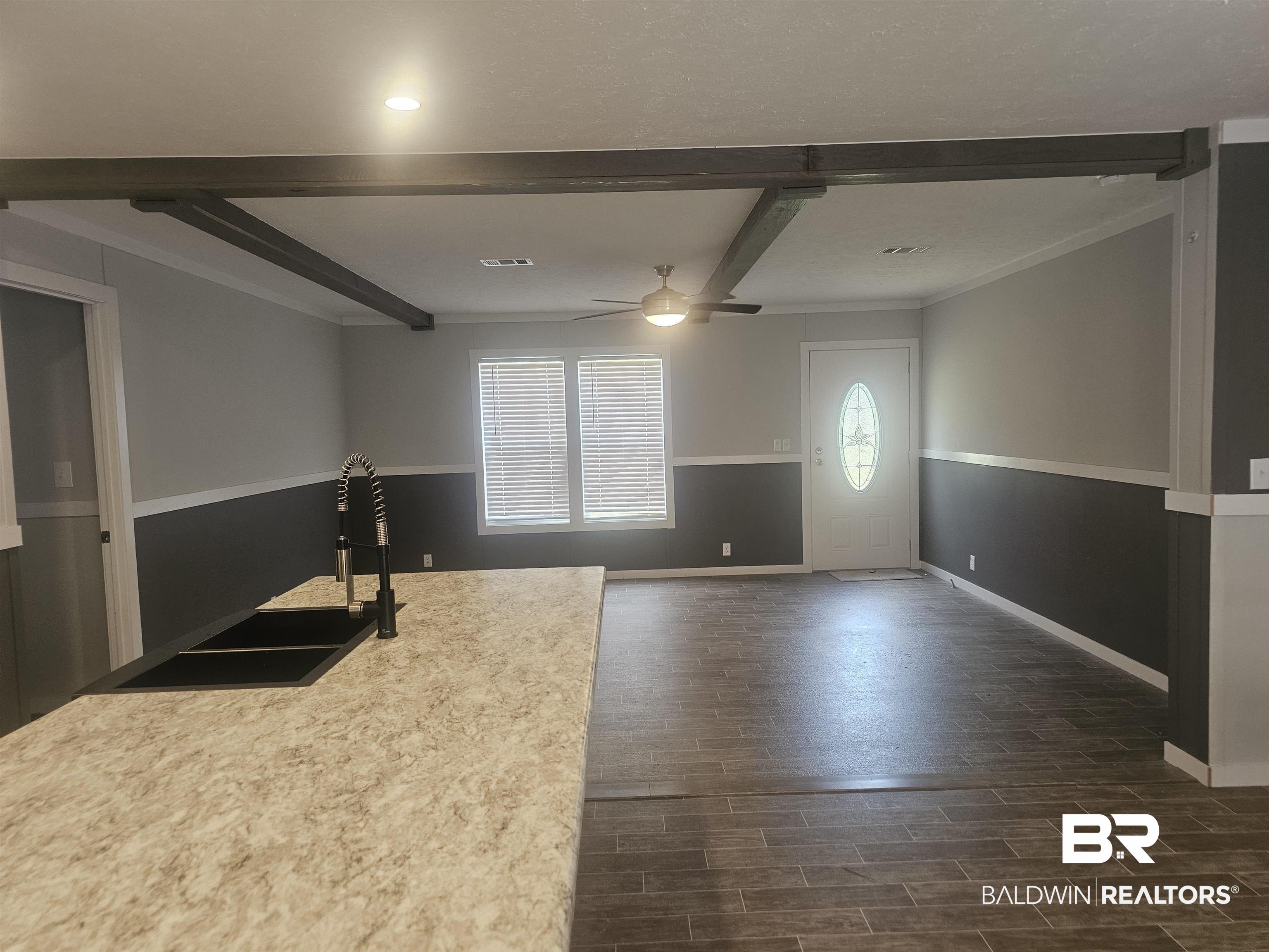 1863 Wait Road Monroeville, AL 36460 - Photo 34 of 38 Interior space with ceiling fan, ornamental molding, dark hardwood / wood-style floors, and beam ceiling