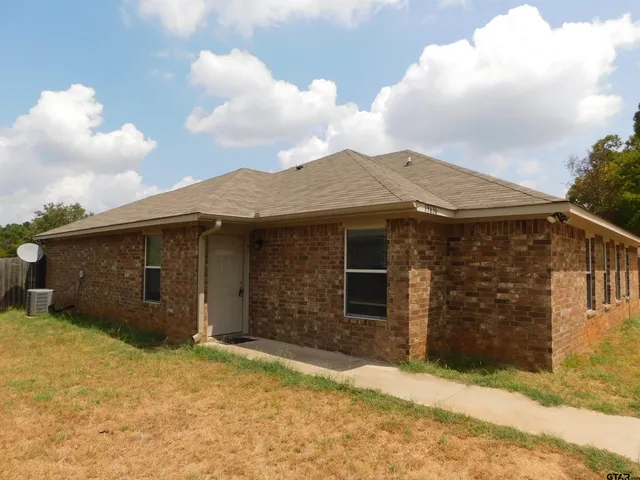 a view of a house with a yard and garage