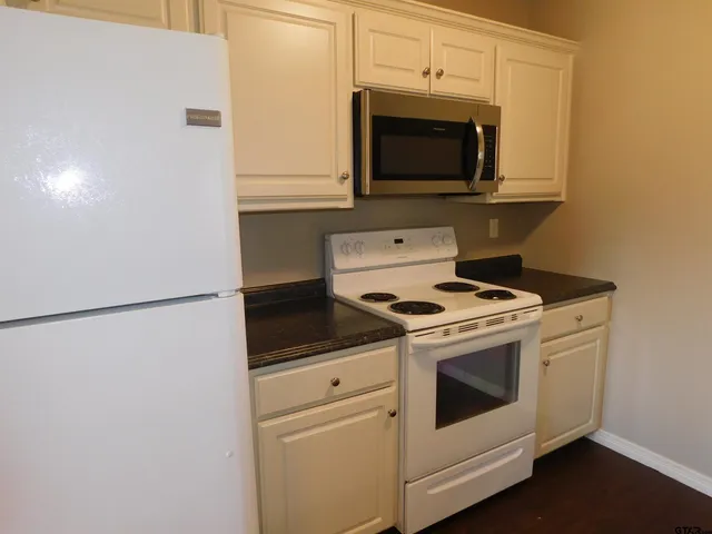 a stove top oven sitting inside of a kitchen